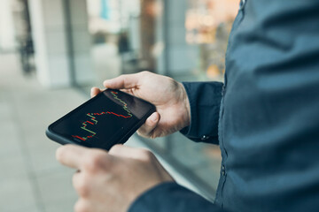 Man investing trading on stock cryptocurrency market using investing application on smartphone
