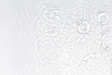 White, transparent and clear water surface with splashes and little bubbles. Water texture. Close up view. Trendy abstract nature background.