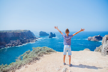 Boy looking out on the ocean. Lagos, Algarve Coast, Portugal