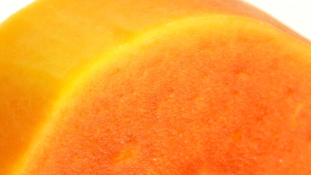 4K Half ripe papaya fruit with seeds. Fragrant tropical fruit pulp. Sweet fisolated resh papaw, raw vegan food isolated on white background
