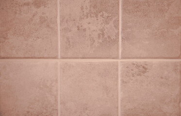 The texture of beige square-shaped tiles.