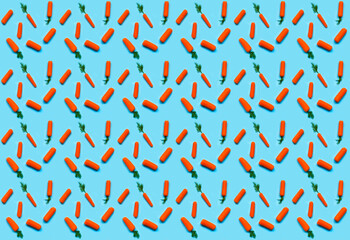 Pattern of carrots on blue background. Design for Easter or wrapping paper. Creative copy space