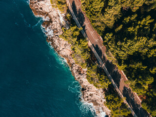  The waves of the Adriatic wash over the rocky shore. High quality photo. A photo from a drone of...