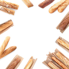 Frame made of freshly baked tasty baguettes on white background, top view