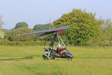 	
Ultralight airplane taxiing on a farm strip	