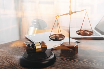 Justice and law concept.Male judge in a courtroom with the gavel, working with, computer and...