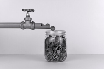 Money Flowing From A Pipe In To A Glass Jar.