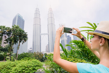Woman photographing skyscrapers.