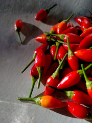 a pile of small, red, very hot and spicy chilli peppers
