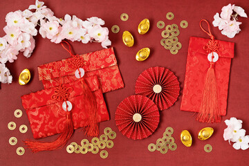 Chinese new year festival decoration over red background. traditional lunar new year red pokets,...