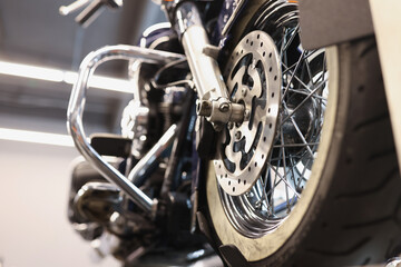 Closeup of brake metal disc on motorcycle wheel
