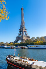 Paris, the Eiffel Tower, with houseboats on the Seine in autumn
