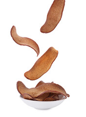 Delicious crispy rusks falling into bowl on white background