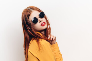 fashionable woman in yellow shirt sunglasses posing
