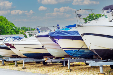 Boat on stand on the shore, close up on the part of the yacht, luxury ship, maintenance and parking...