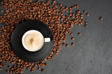 A fragrant cup of coffee Cappuccino on a black wooden background. Top view. Copy space.