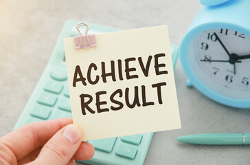 Achieve results Businessman holding a card with a motivational message written on it