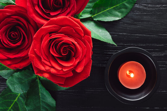 Red Roses and Red Candle on Black Background