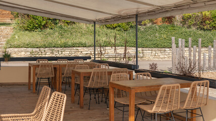 Outdoor area with wicker chair under cover