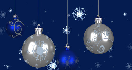 Image of christmas baubles over snowflakes on blue background