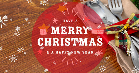 Image of merry christmas text over cutlery on table