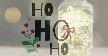Image of ho ho ho text over christmas lights