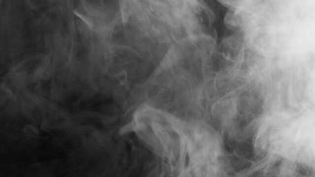 Thick smoke on a black background. Gray fog. Smoke and fire.