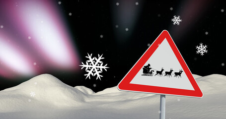 Naklejka premium Image of snow falling at christmas over sign with santa in sleigh