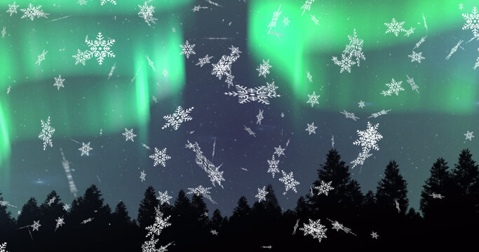 Image of snow falling at christmas over aurora and winter scenery