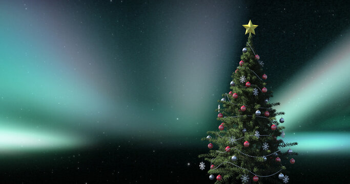 Image of christmas tree over aurora