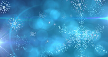 Image of christmas snowflakes falling over blue bokeh background