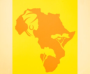 silhouette of the African continent with trees and the head of a woman in a turban and with earrings. Background for black history month or happy kwanzaa