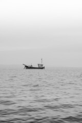 Obraz premium fishing boat in the fog