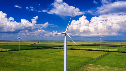 View from Drone at windpark and windmill farm. Wind turbine from aerial view.