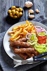 cevapcici with potato fries, lettuce, onion, ajvar