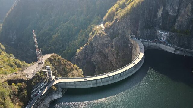 Aerial drone view of nature in Romania. Valley in Carpathian mountains with Vidraru dam and lake, slopes with lush forest