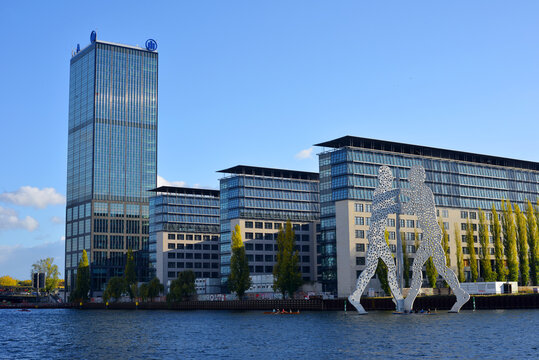 Berlin, Germany 10-23-2021 view to the Treptower skyscraper and the molecule man sculpture