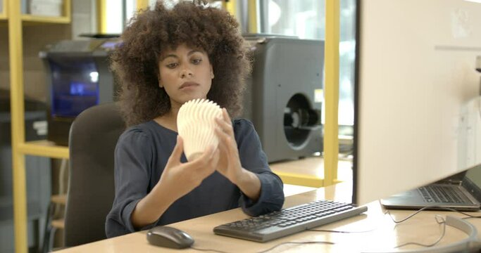 Afro American Female Technician working on computer with 3D model