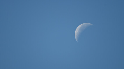 View of the daylight moon in the blue sky, Oahu, Hawaii (right hand)