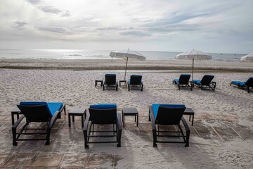 Empty sun beds at the beach of the hotel in relief of the epidemic