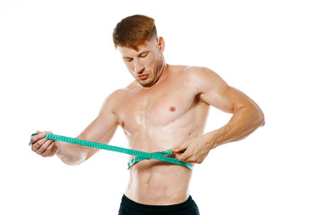 athletic man with measuring tape muscle workout