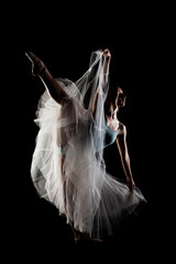 ballerina with a white dress and black top posing on black background © Nikola Spasenoski