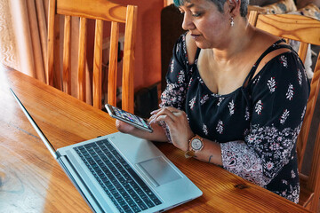 One-armed woman working on laptop at home
