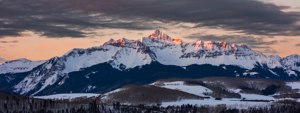 Scenic winter landscape with sunrise light on the snowcapped San Juan Mountains in Telluride, Colorado