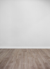 Empty room with white wall and wooden floor