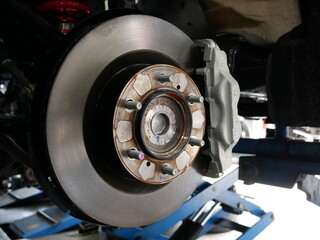 maintaining car wheel brake disc at repair service station.	
