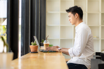 Young Asian men, future students for self or personal learning ideas. Online students at coffee shops with books and laptops.