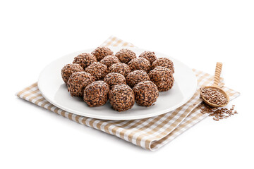 Plate with tasty flax seed candies on white background