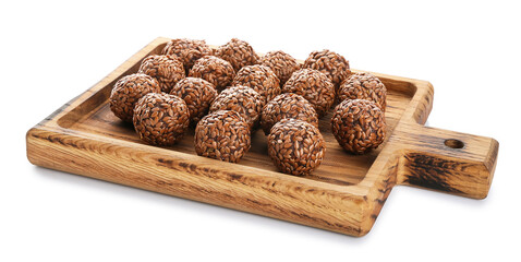 Board with tasty flax seed candies on white background