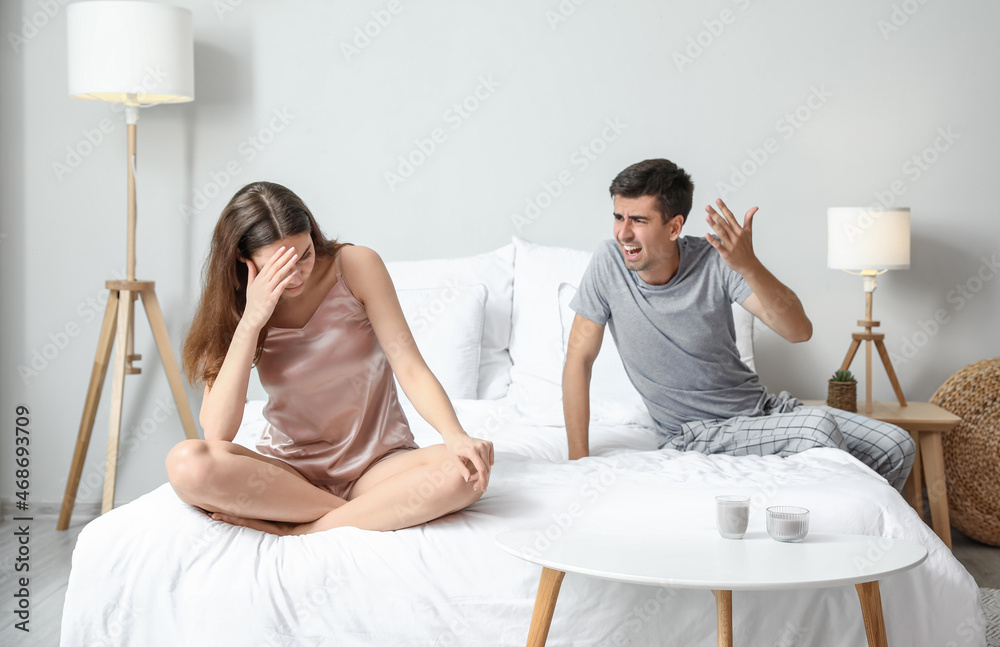 Poster angry young man shouting at his wife in bedroom